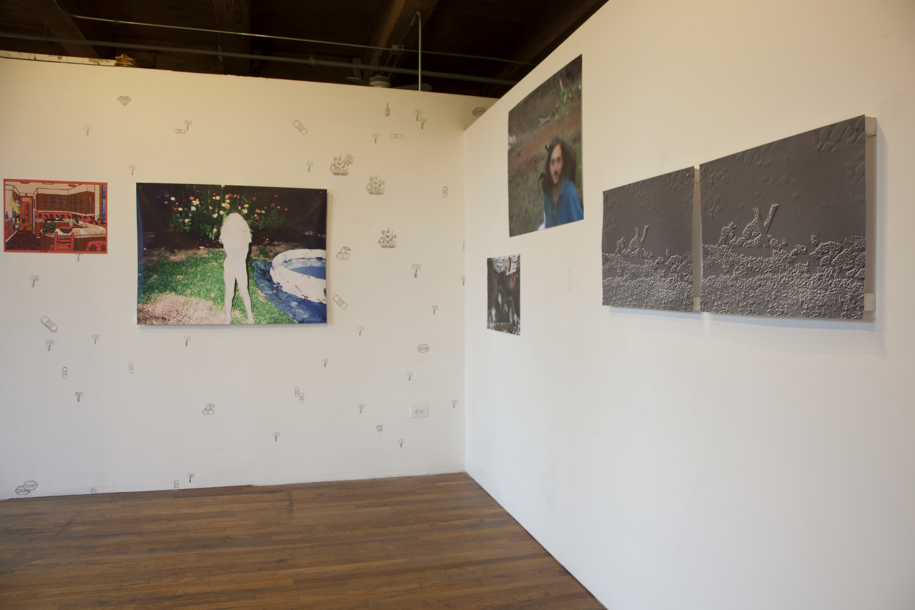 Installation view of six large scale prints hung on white walls with Kidpix graphics drawn in pencil on them